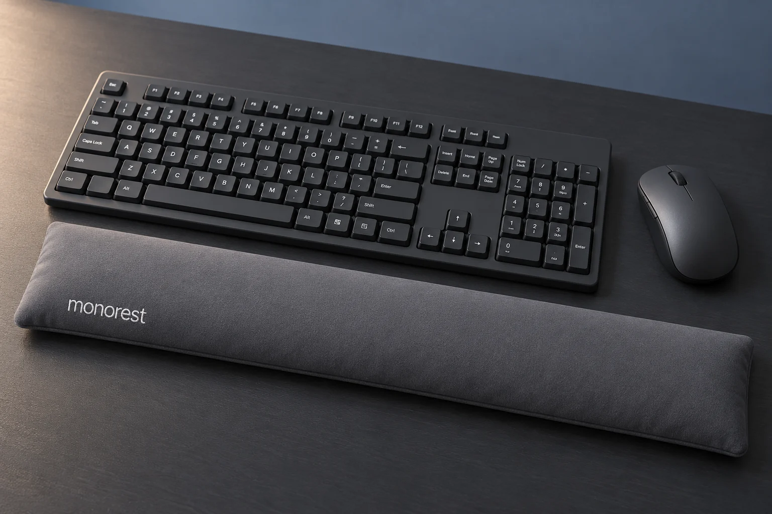 AI-styled close-up of a keyboard and mouse with a grey MONOREST wrist rest spanning both zones. Accessories not included.